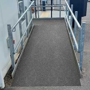 GRP flat sheets stacked in a warehouse ready for industrial flooring use