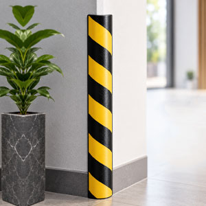 : Rubber wall corner protector fitted to an exposed wall corner in a commercial premises