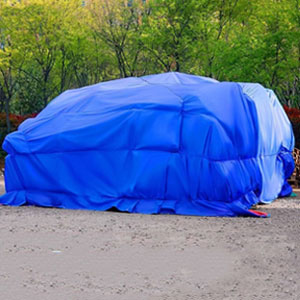 Industrial tarpaulins covering stored goods and materials on a commercial site